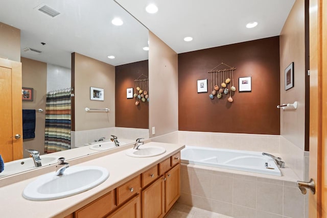 1325 N Van Buren St Unit 308, Milwaukee, WI 53202 - bathroom featuring a garden tub, recessed lighting, double vanity, tile patterned floors, and a shower with curtain