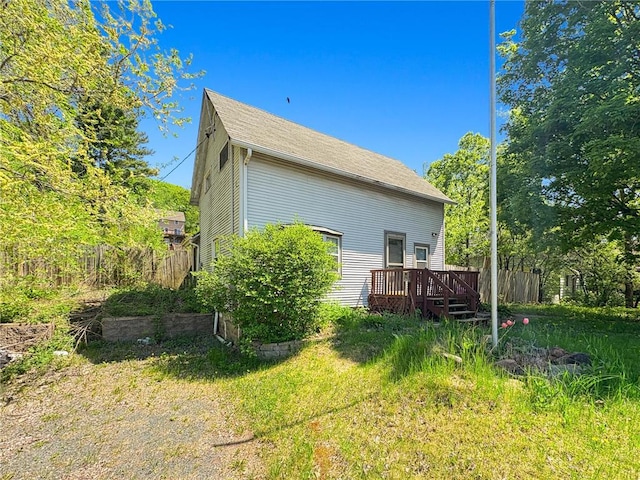 438 N Washington St, Saint Croix Falls, WI 54024 - view of home's exterior featuring a deck and fence