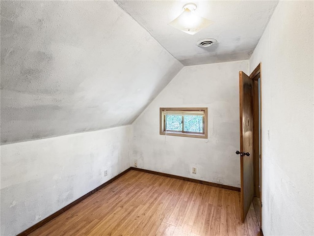 438 N Washington St, Saint Croix Falls, WI 54024 - bonus room with light wood-style flooring, lofted ceiling, and baseboards