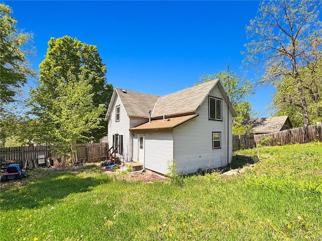 438 N Washington St, Saint Croix Falls, WI 54024 - rear view of house featuring a shingled roof
