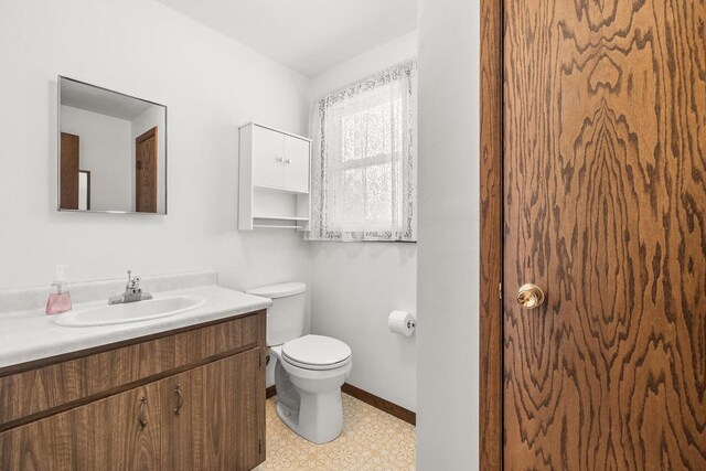 7256 State Highway 66, Custer, WI 54423 - bathroom featuring toilet, vanity, and baseboards