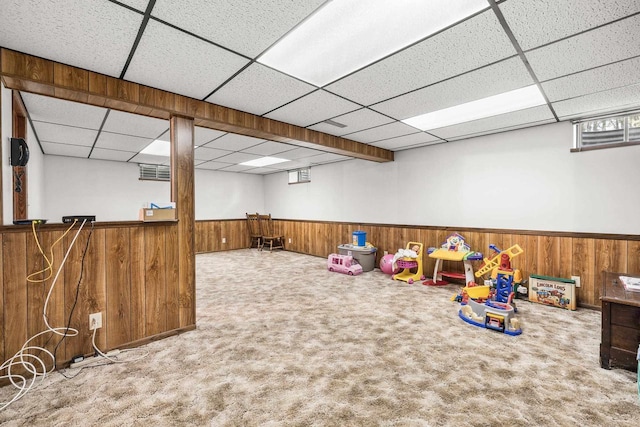 7256 State Highway 66, Custer, WI 54423 - playroom featuring a drop ceiling, wooden walls, carpet flooring, wainscoting, and plenty of natural light