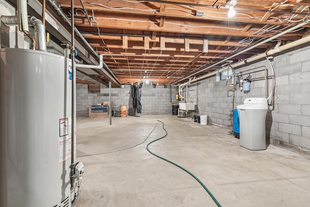 7256 State Highway 66, Custer, WI 54423 - unfinished basement featuring gas water heater, a water softener, and a sink