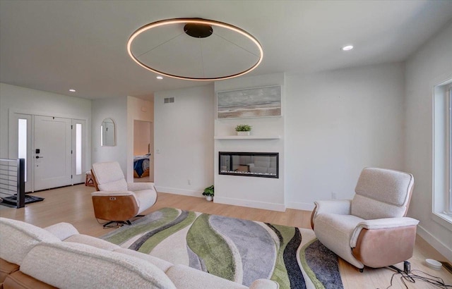 6612 Vista Vly, Windsor, WI 53598 - living area featuring a glass covered fireplace, light wood finished floors, recessed lighting, and baseboards