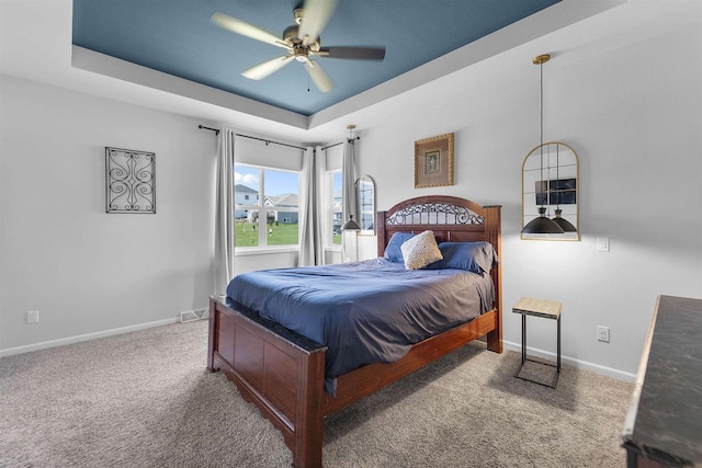 432 Tawny Elm Pkwy, Verona, WI 53593 - carpeted bedroom featuring a tray ceiling, baseboards, and a ceiling fan