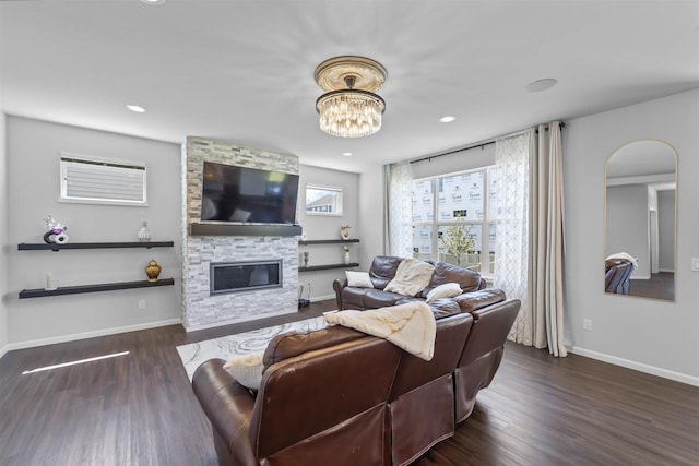 432 Tawny Elm Pkwy, Verona, WI 53593 - living area with wood finished floors, baseboards, a stone fireplace, arched walkways, and recessed lighting