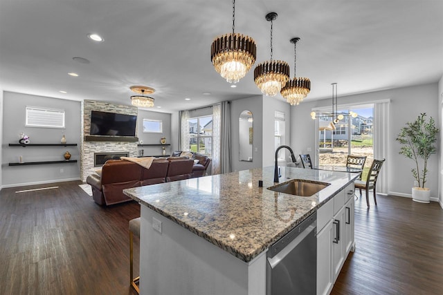 432 Tawny Elm Pkwy, Verona, WI 53593 - kitchen with a sink, dishwasher, a chandelier, dark wood-type flooring, and a stone fireplace