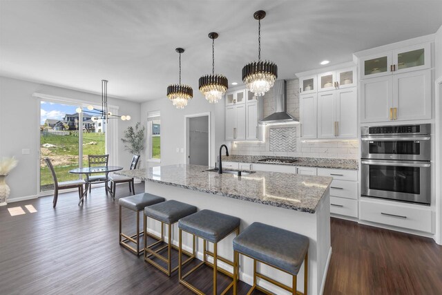 432 Tawny Elm Pkwy, Verona, WI 53593 - kitchen with a sink, a chandelier, wall chimney exhaust hood, stainless steel appliances, and tasteful backsplash