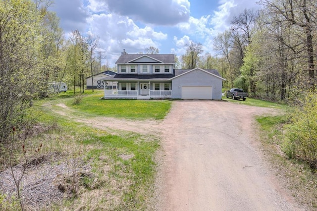 175545 Willow Ln, Ringle, WI 54440 - view of front of property with covered porch, dirt driveway, an attached garage, and a front yard