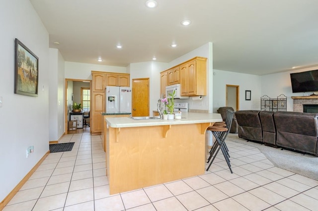175545 Willow Ln, Ringle, WI 54440 - kitchen with white appliances, open floor plan, a kitchen bar, light countertops, and recessed lighting