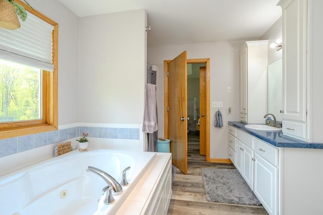 175545 Willow Ln, Ringle, WI 54440 - full bath with wood finished floors, a jetted tub, and vanity