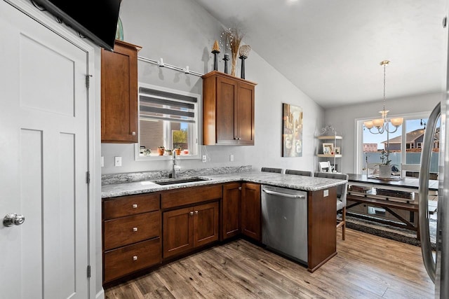 1397 Lear Ln, De Pere, WI 54115 - kitchen with a sink, dishwasher, vaulted ceiling, wood finished floors, and a peninsula