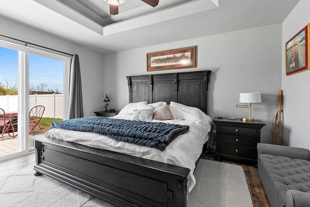 1397 Lear Ln, De Pere, WI 54115 - bedroom with access to exterior, a raised ceiling, wood finished floors, and a ceiling fan
