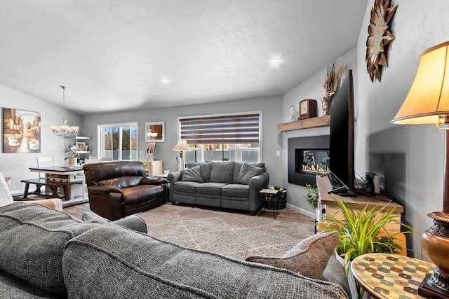 1397 Lear Ln, De Pere, WI 54115 - living area featuring a chandelier, baseboards, wood finished floors, and a large fireplace