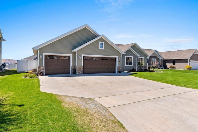 1397 Lear Ln, De Pere, WI 54115 - craftsman house with concrete driveway, a front yard, stone siding, and an attached garage