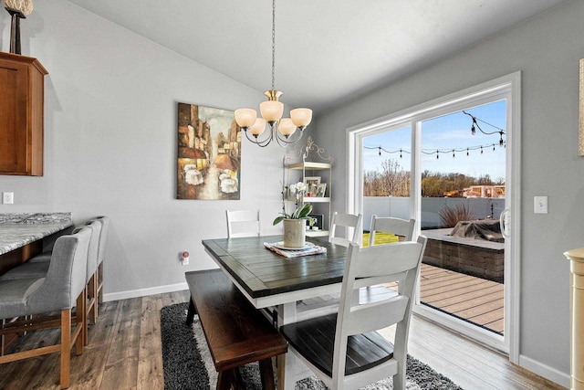 1397 Lear Ln, De Pere, WI 54115 - dining room with wood finished floors, a chandelier, baseboards, and lofted ceiling