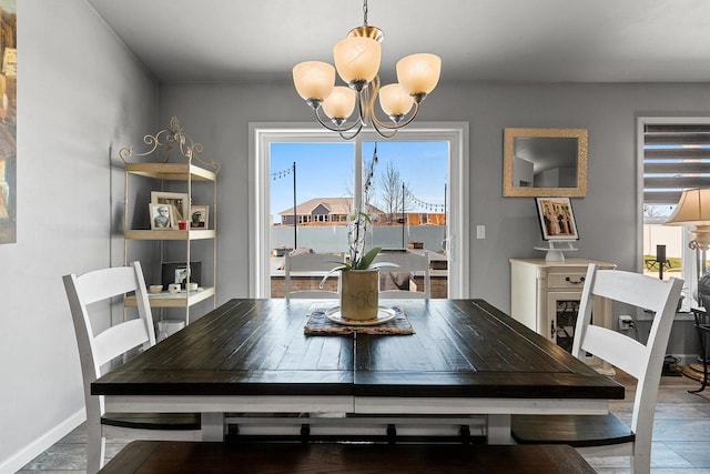 1397 Lear Ln, De Pere, WI 54115 - dining area with a chandelier, wood finished floors, and baseboards