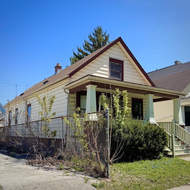 2664 N Booth St, Milwaukee, WI 53212 - bungalow-style home with a porch, a chimney, and roof with shingles