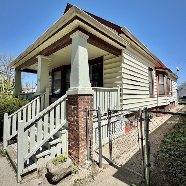 2664 N Booth St, Milwaukee, WI 53212 - view of home's exterior with covered porch, a gate, and fence