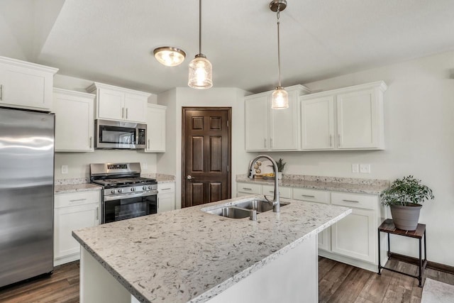 5208 Briarwood Cir, Racine, WI 53402 - kitchen featuring stainless steel appliances, a sink, white cabinetry, dark wood-style flooring, and hanging light fixtures