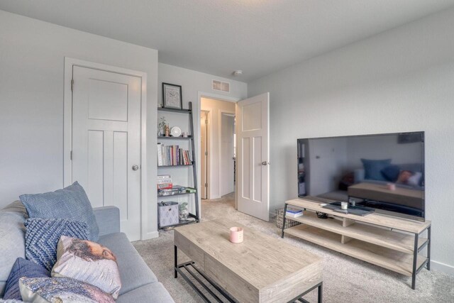 living room featuring light carpet