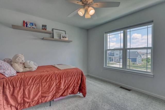 carpeted bedroom with baseboards and a ceiling fan