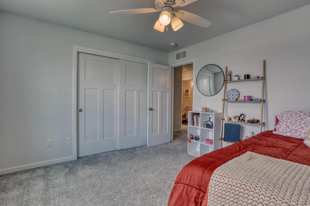 carpeted bedroom featuring a closet, ceiling fan, and baseboards