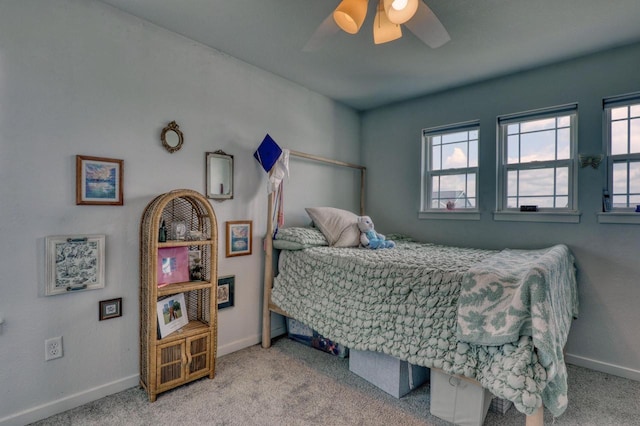 bedroom with baseboards, carpet floors, and multiple windows