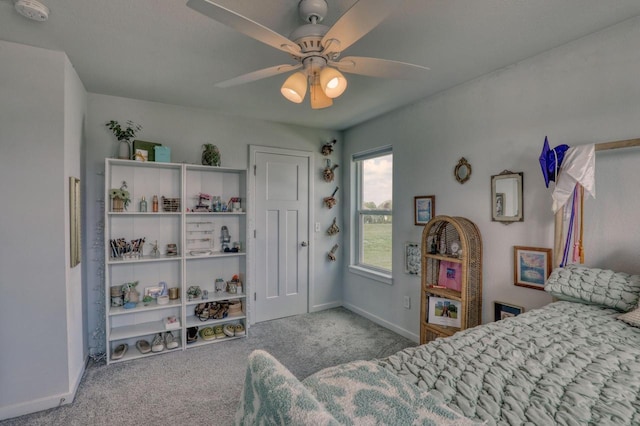 carpeted bedroom featuring baseboards and a ceiling fan