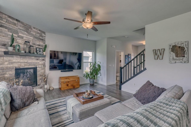 living room with a ceiling fan, stairs, wood finished floors, and baseboards
