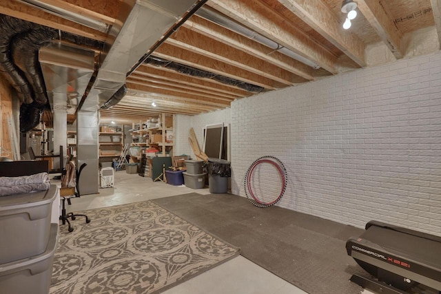 unfinished basement featuring brick wall
