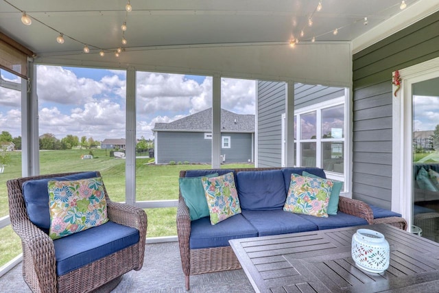 sunroom featuring an outdoor hangout area and track lighting