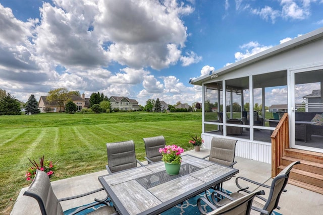 view of patio / terrace with a sunroom and outdoor dining area