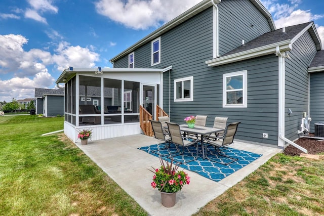 back of house with a sunroom, a patio area, a lawn, and central air condition unit