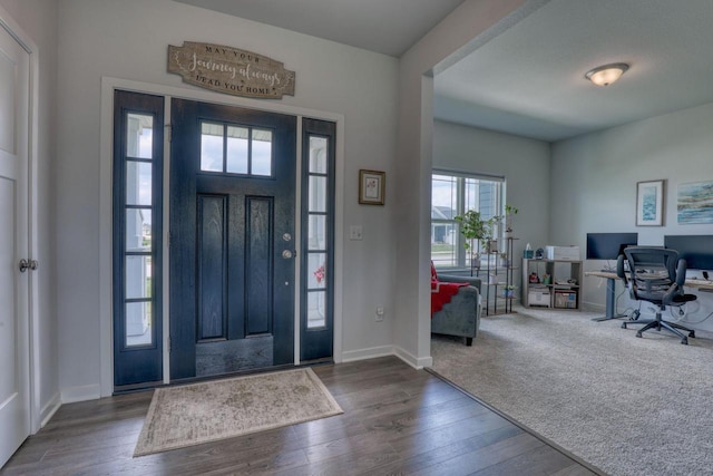 entryway with wood finished floors and baseboards