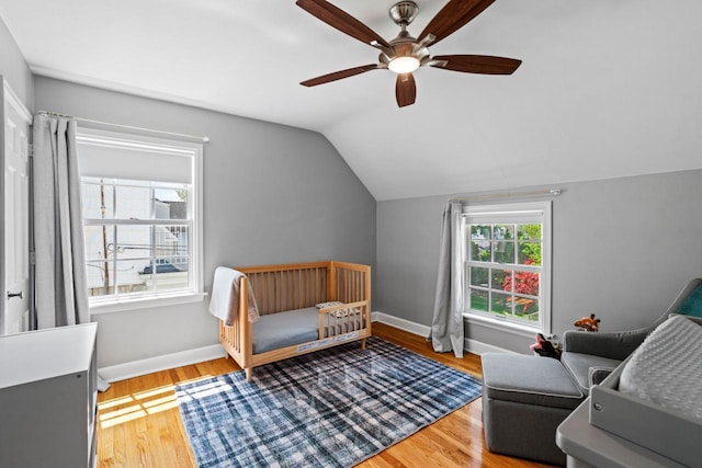 2577 N 89th St, Wauwatosa, WI 53226 - bedroom with lofted ceiling, light wood-style flooring, baseboards, and a ceiling fan