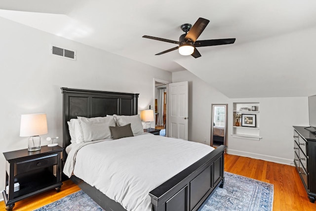 2577 N 89th St, Wauwatosa, WI 53226 - bedroom with vaulted ceiling, light wood-style floors, a ceiling fan, and baseboards