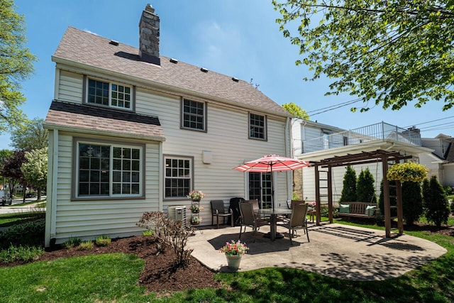 2577 N 89th St, Wauwatosa, WI 53226 - back of house featuring a balcony, a patio area, a chimney, cooling unit, and a shingled roof