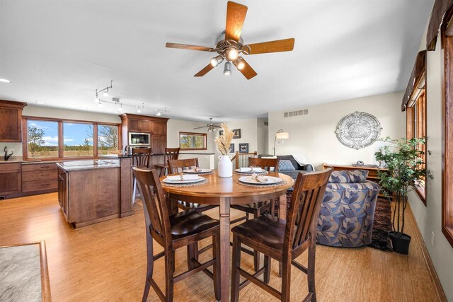 169003 Shorewood Dr, Rosholt, WI 54473 - dining room featuring light wood-style flooring and ceiling fan