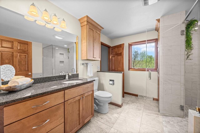 169003 Shorewood Dr, Rosholt, WI 54473 - full bathroom with a shower stall, baseboards, vanity, and toilet