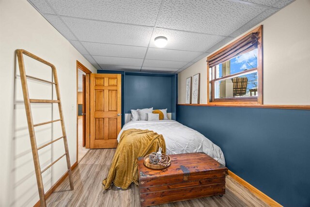 169003 Shorewood Dr, Rosholt, WI 54473 - bedroom with a drop ceiling, light wood-type flooring, and baseboards