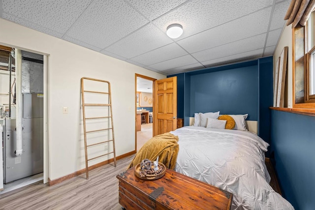 169003 Shorewood Dr, Rosholt, WI 54473 - bedroom with light wood finished floors, a paneled ceiling, and baseboards