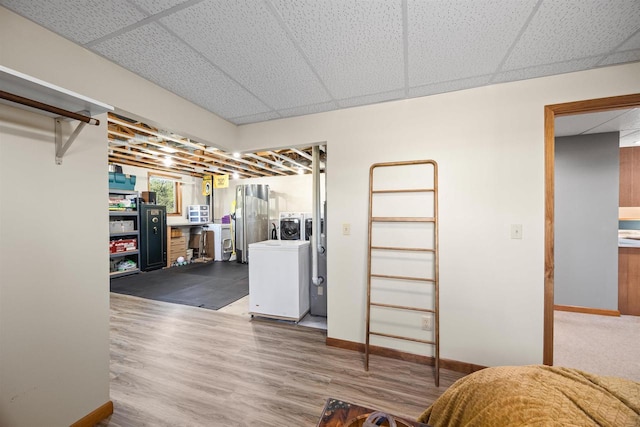 169003 Shorewood Dr, Rosholt, WI 54473 - living room featuring washer / clothes dryer, baseboards, and wood finished floors