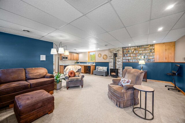 169003 Shorewood Dr, Rosholt, WI 54473 - living room with a wood stove, a paneled ceiling, recessed lighting, and baseboards