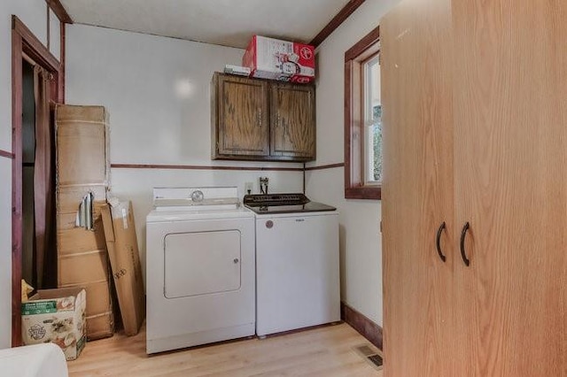2139 12th St, Eau Claire, WI 54703 - laundry area with independent washer and dryer, cabinet space, and light wood-type flooring