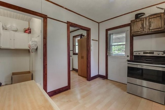 2139 12th St, Eau Claire, WI 54703 - kitchen featuring stainless steel electric range oven, light wood finished floors, light countertops, baseboards, and ornamental molding