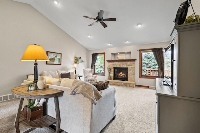 N5798 Lakeview Dr, Green Lake, WI 54941 - living area featuring carpet, lofted ceiling, ceiling fan, baseboards, and a stone fireplace