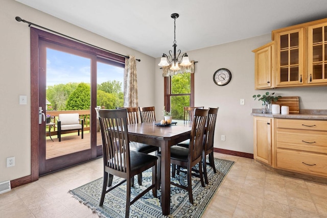 N5798 Lakeview Dr, Green Lake, WI 54941 - dining space featuring a chandelier and baseboards