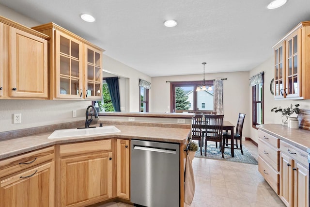 N5798 Lakeview Dr, Green Lake, WI 54941 - kitchen featuring stainless steel dishwasher, a sink, light brown cabinetry, a peninsula, and glass insert cabinets