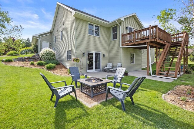 N5798 Lakeview Dr, Green Lake, WI 54941 - back of property with an outdoor fire pit, stairway, a wooden deck, a lawn, and a patio